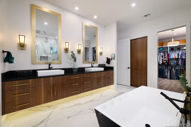 a large kitchen with kitchen island a sink stainless steel appliances and cabinets