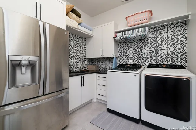 a kitchen with stainless steel appliances granite countertop a refrigerator and a stove