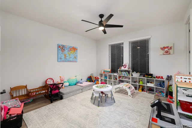 a living room with furniture and a book shelf