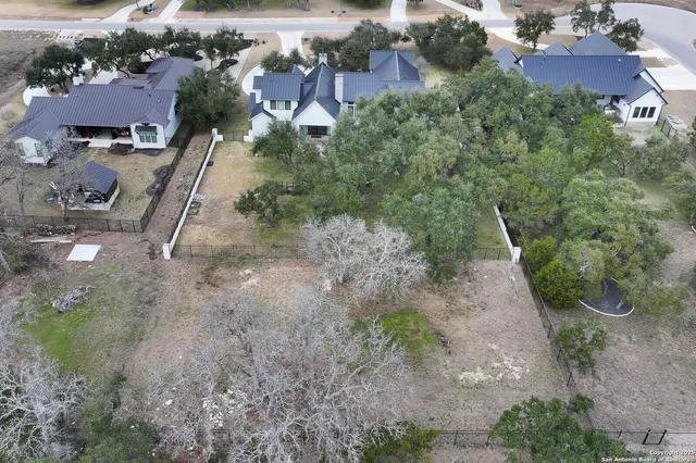 an aerial view of a house with outdoor space