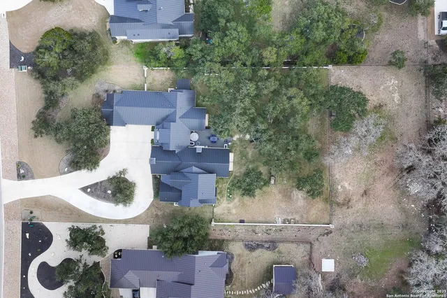 an aerial view of a house with a swimming pool