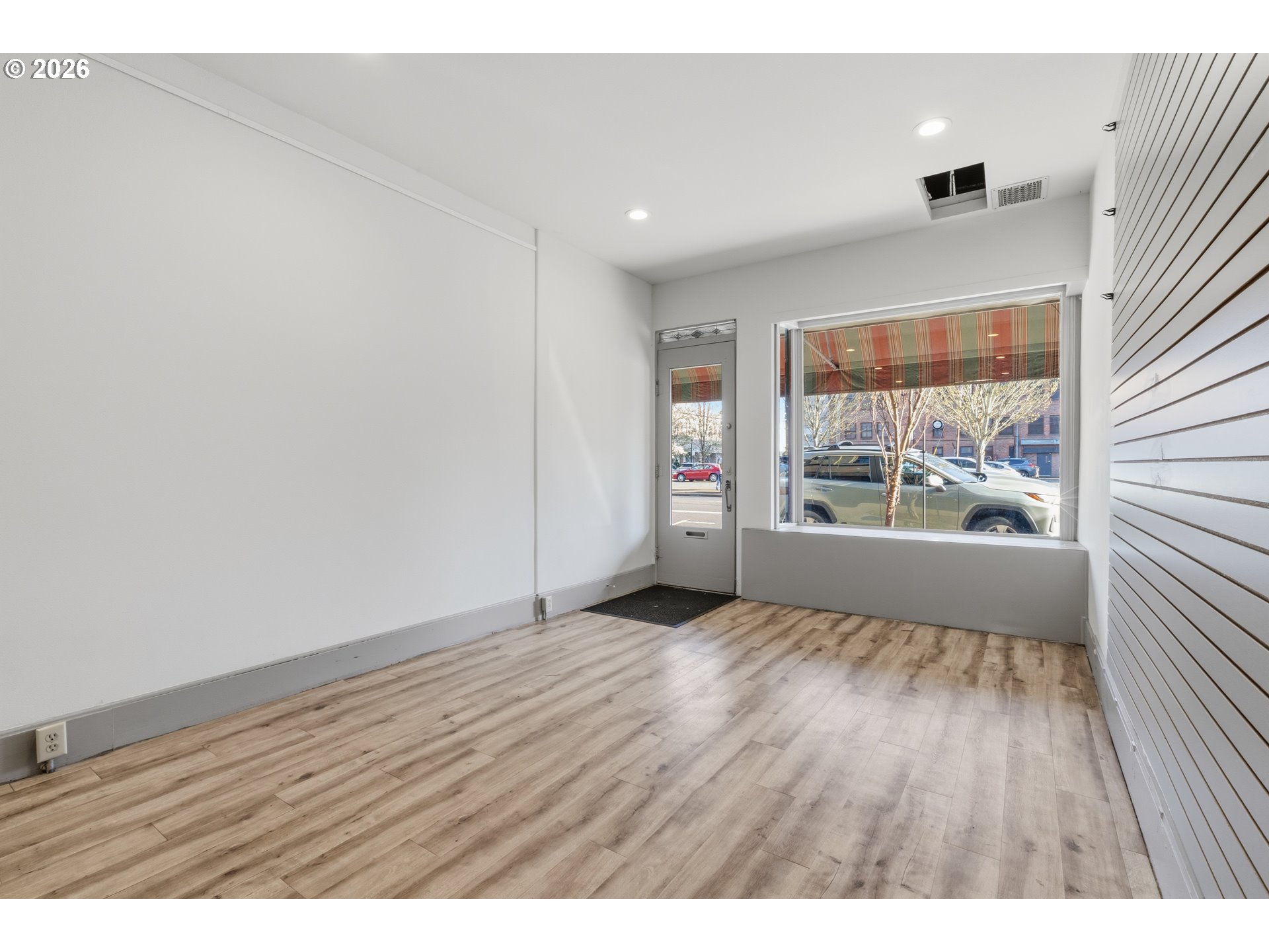 309 West 1st Avenue Albany, OR 97321 - Photo 6 of 39 wooden floor in an empty room with a window