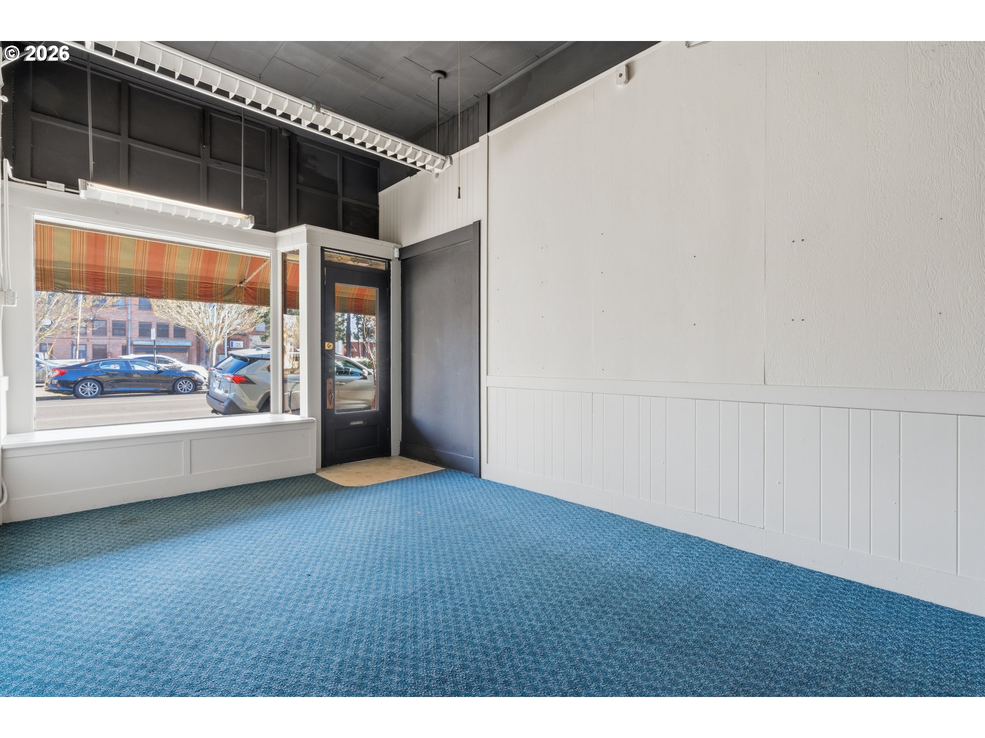 309 West 1st Avenue Albany, OR 97321 - Photo 10 of 39 a view of an empty room with window and wooden floor