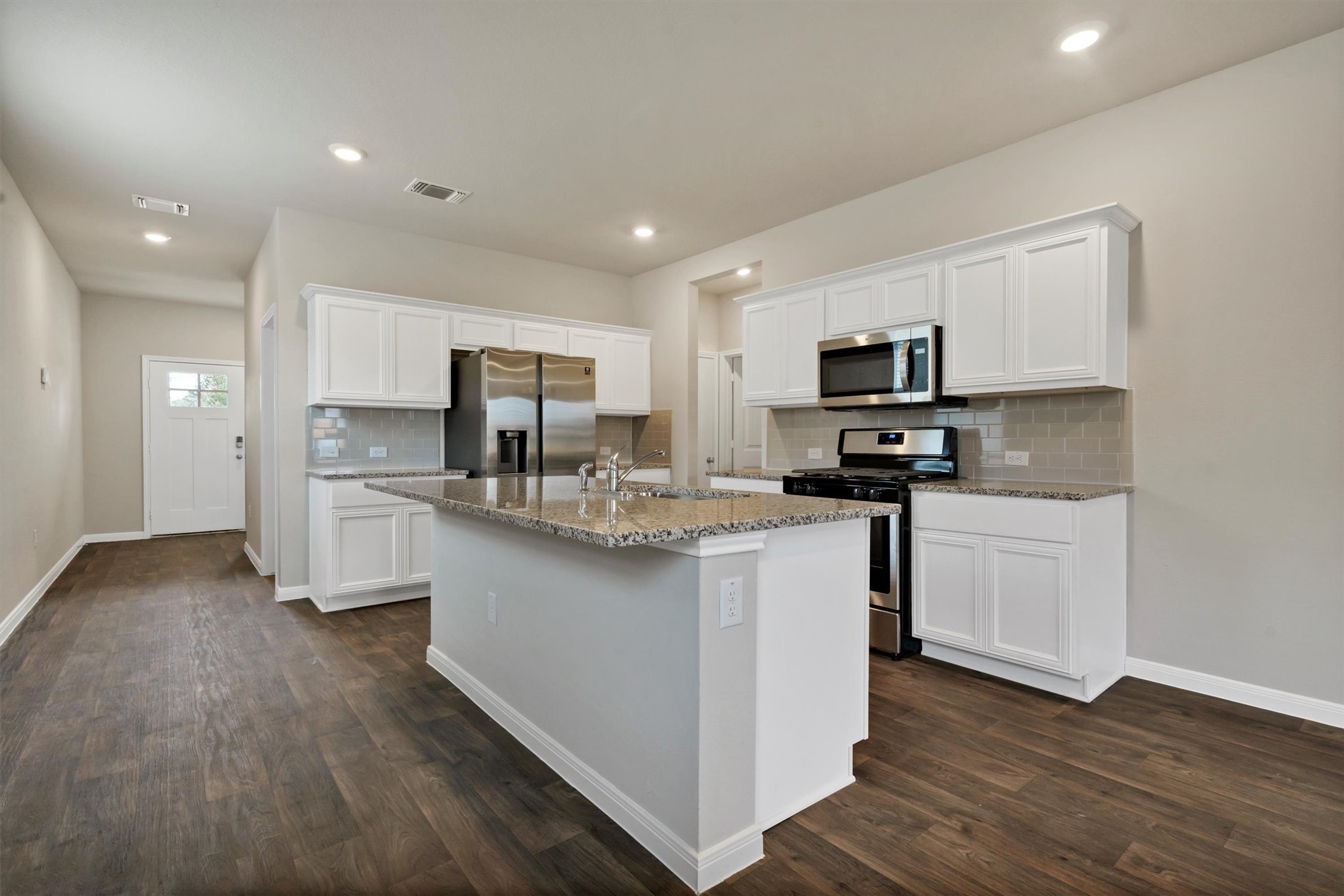 2909 Tweedy Trail Pflugerville, TX 78660 - Photo 15 of 27 A well-appointed kitchen showcasing an inviting center island with elegant granite counters and modern stainless steel appliances.
