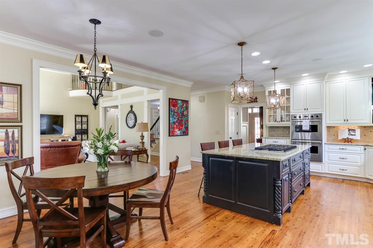 3329 Harden Road Raleigh, NC 27607 - Photo 13 of 29 a view of a dining room and livingroom with furniture wooden floor a chandelier