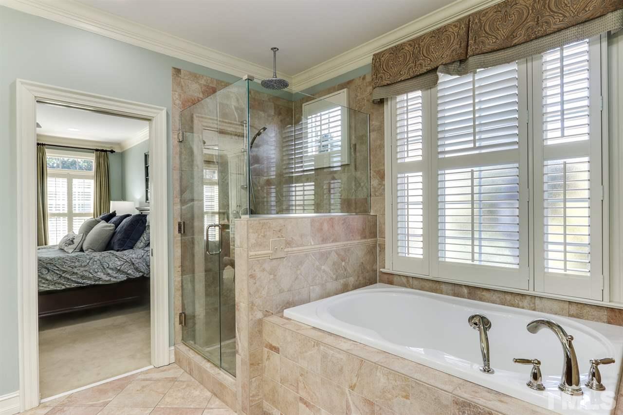 3329 Harden Road Raleigh, NC 27607 - Photo 17 of 29 a bathroom with a tub sink and shower