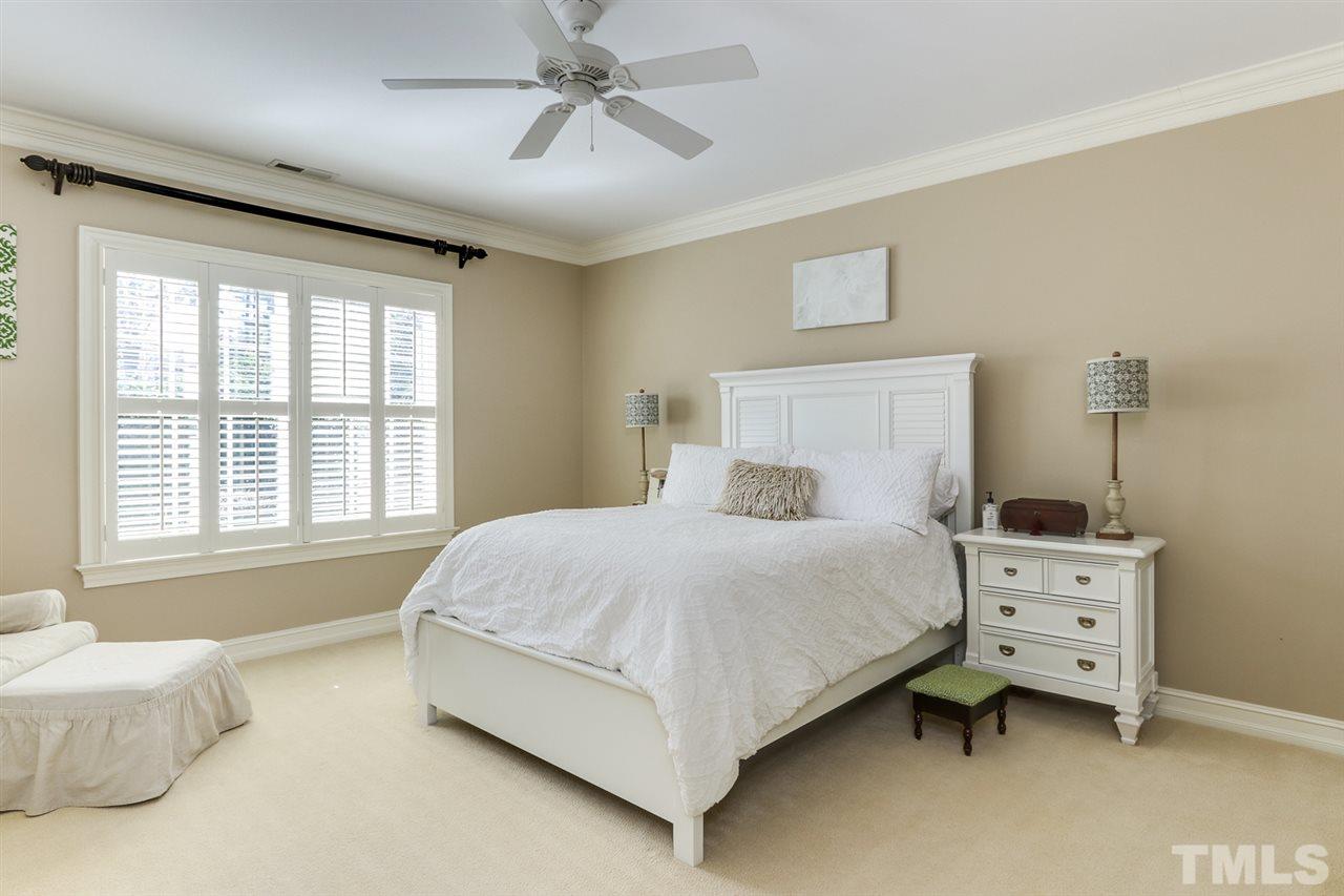 3329 Harden Road Raleigh, NC 27607 - Photo 21 of 29 a bedroom with a bed and a chandelier