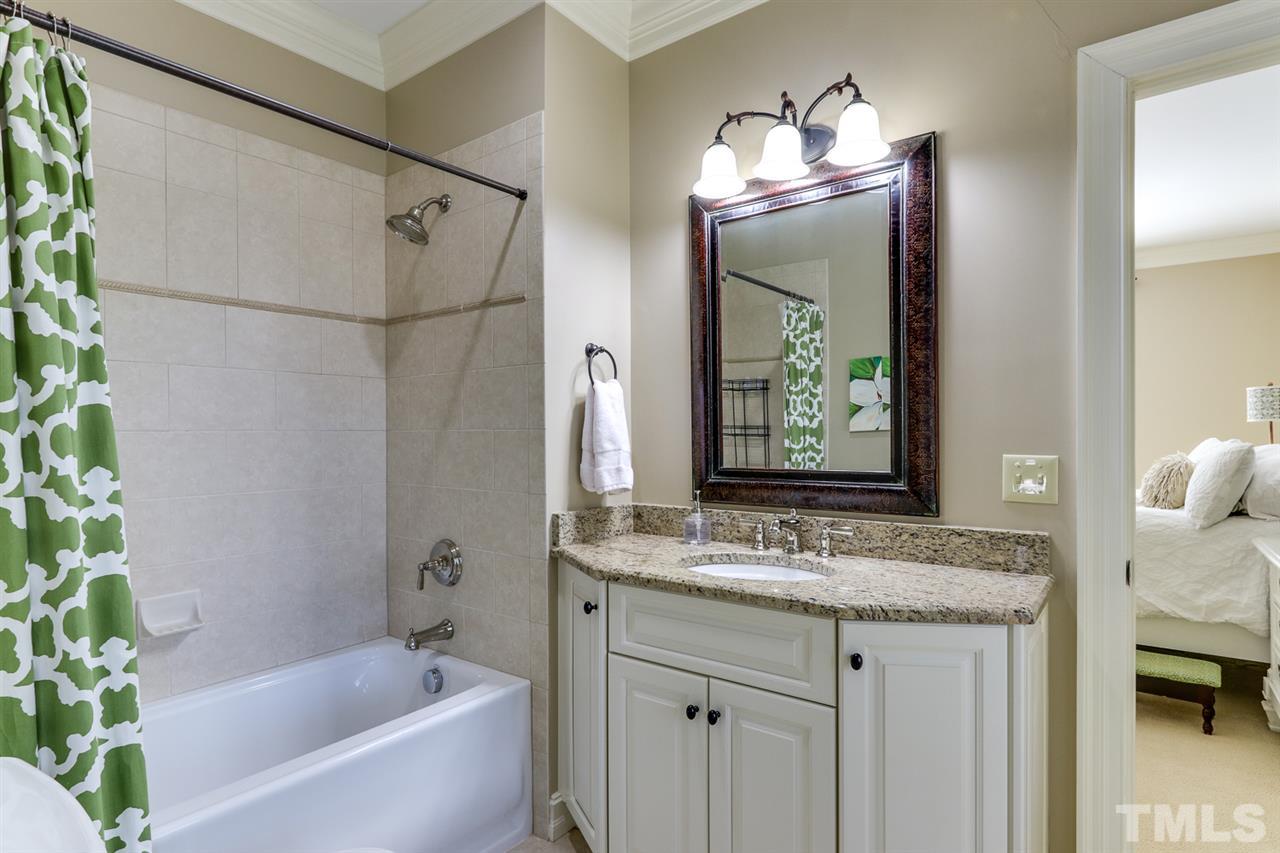 3329 Harden Road Raleigh, NC 27607 - Photo 22 of 29 a bathroom with a granite countertop tub sink and mirror