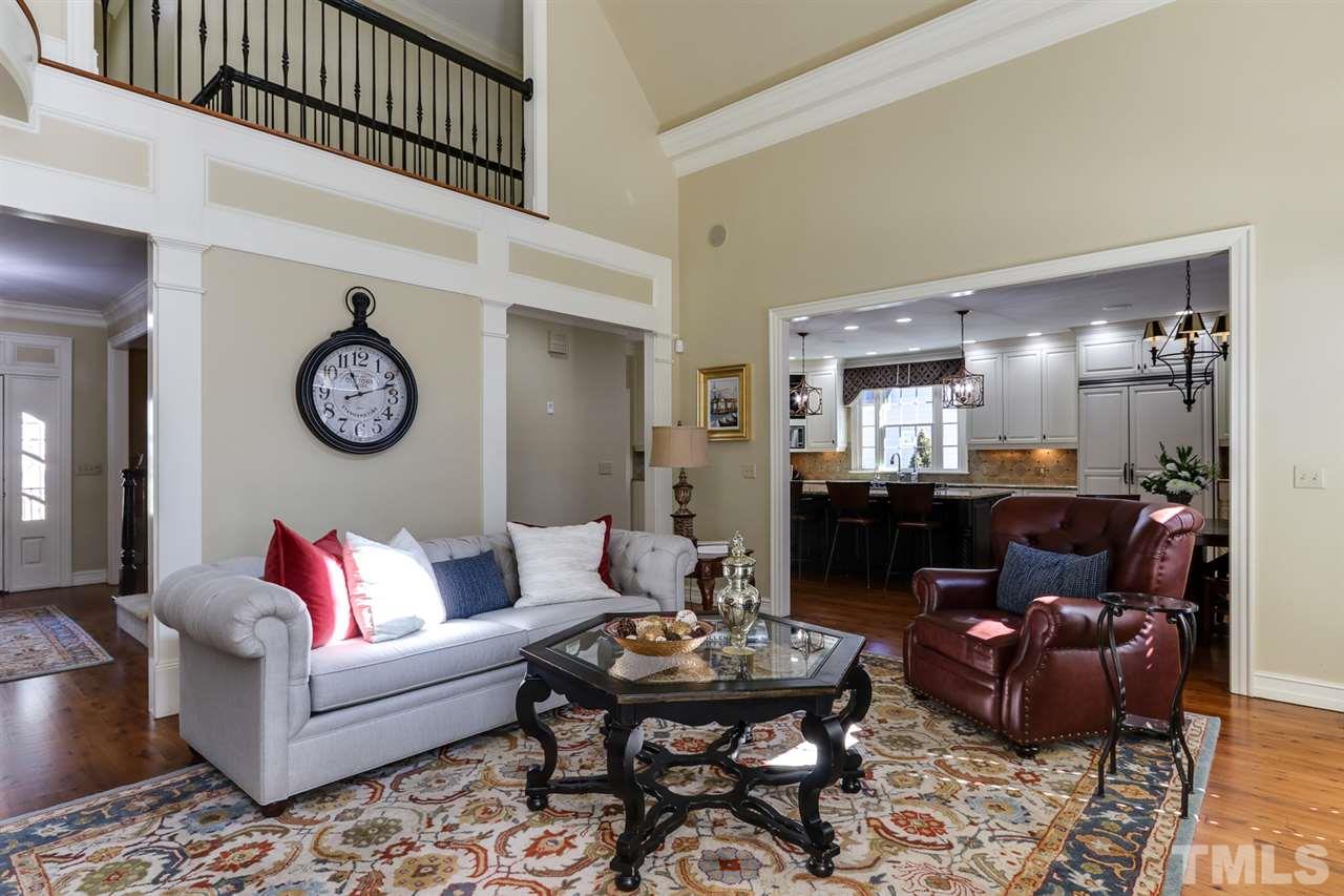 3329 Harden Road Raleigh, NC 27607 - Photo 9 of 29 a living room with furniture a clock on wall and a table