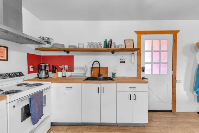 a kitchen with stainless steel appliances a refrigerator and a stove