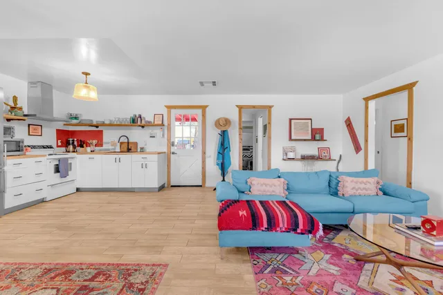 a bathroom with a toilet sink vanity and mirror
