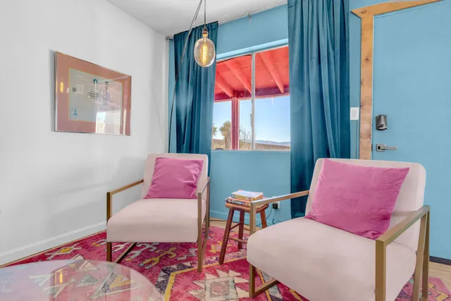 a bed room with a bed mirror and a window