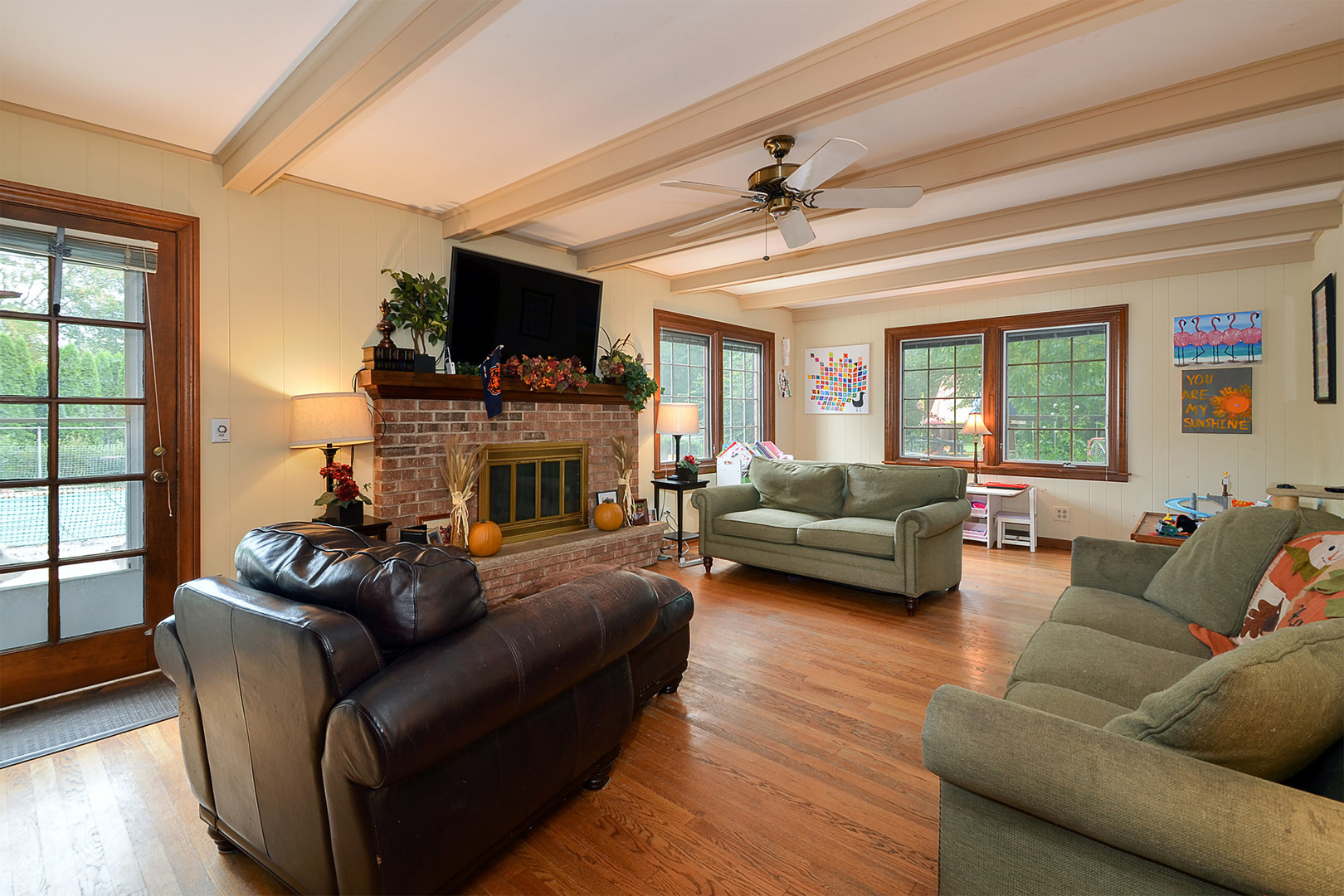 1455 Appleby Road Inverness, IL 60067 - Photo 7 of 16 a living room with furniture a flat screen tv and a fireplace