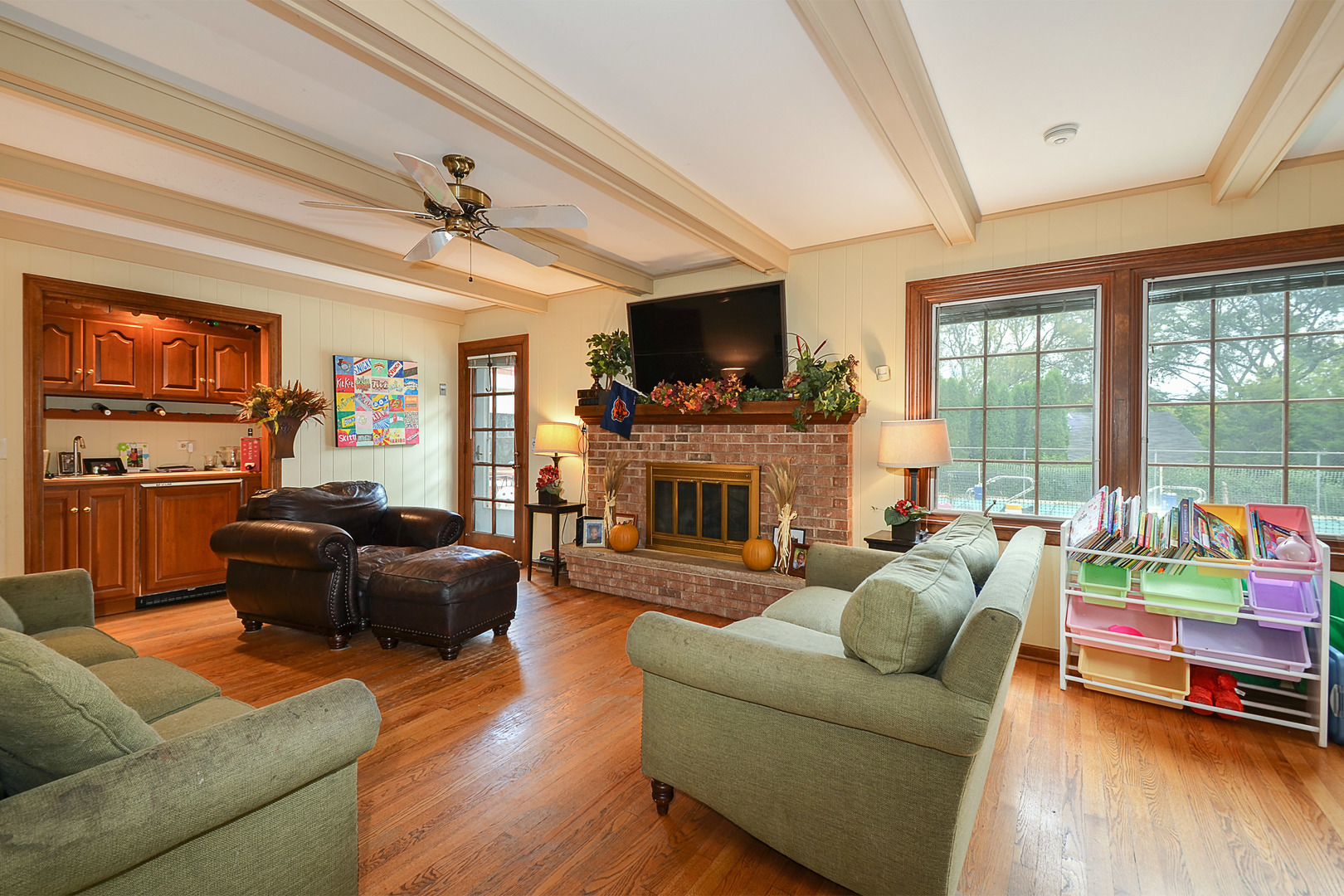 1455 Appleby Road Inverness, IL 60067 - Photo 8 of 16 a living room with furniture a flat screen tv and a fireplace