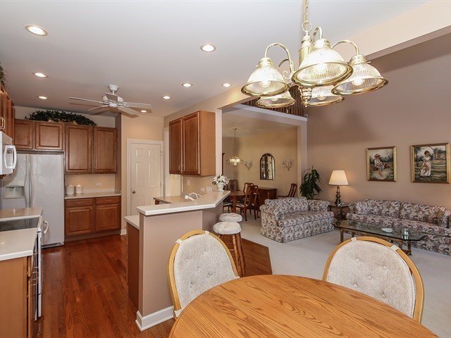 804 Stone Canyon Circle Inverness, IL 60010 - Photo 11 of 30 a view of a dining room kitchen island with furniture and wooden floor