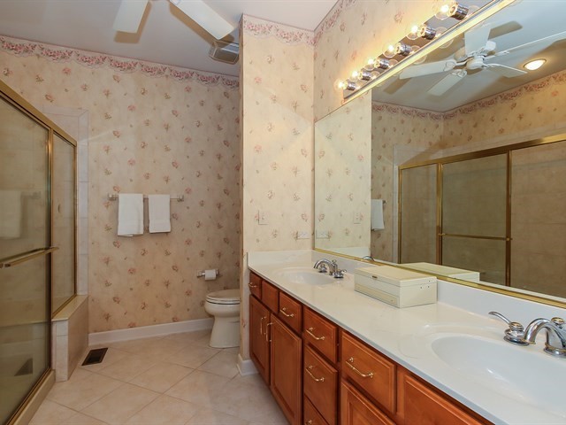 804 Stone Canyon Circle Inverness, IL 60010 - Photo 16 of 30 a spacious bathroom with a double vanity sink toilet and a shower