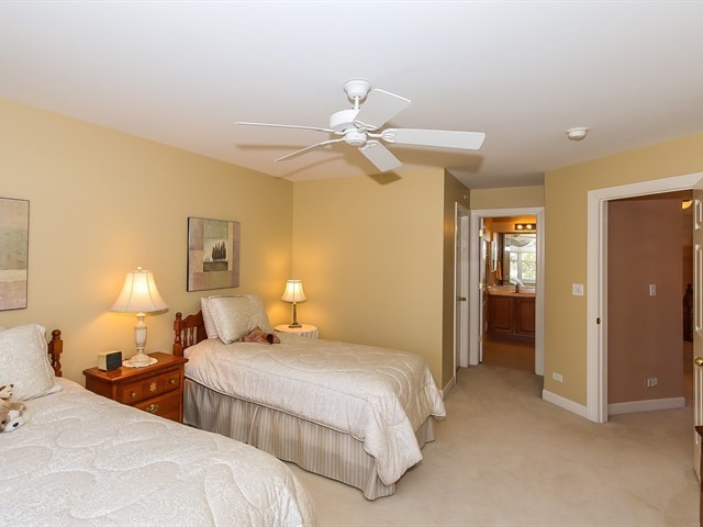 804 Stone Canyon Circle Inverness, IL 60010 - Photo 23 of 30 a bedroom with two beds and a chandelier