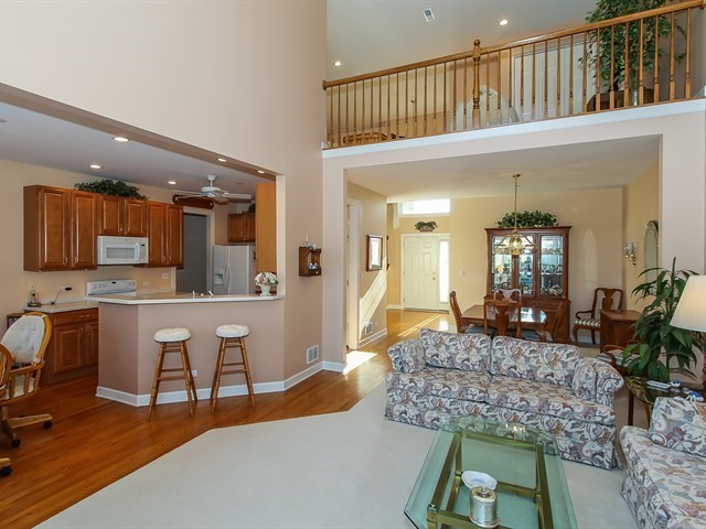 804 Stone Canyon Circle Inverness, IL 60010 - Photo 7 of 30 a living room with furniture a flat screen tv and kitchen view