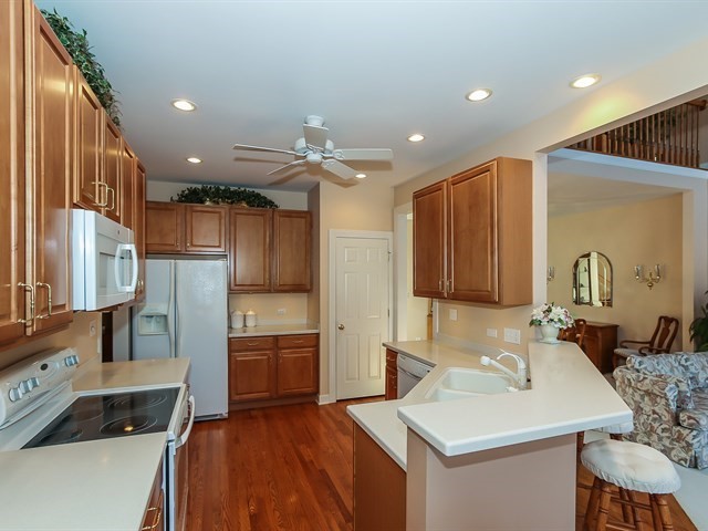 804 Stone Canyon Circle Inverness, IL 60010 - Photo 8 of 30 a kitchen with a sink refrigerator and cabinets