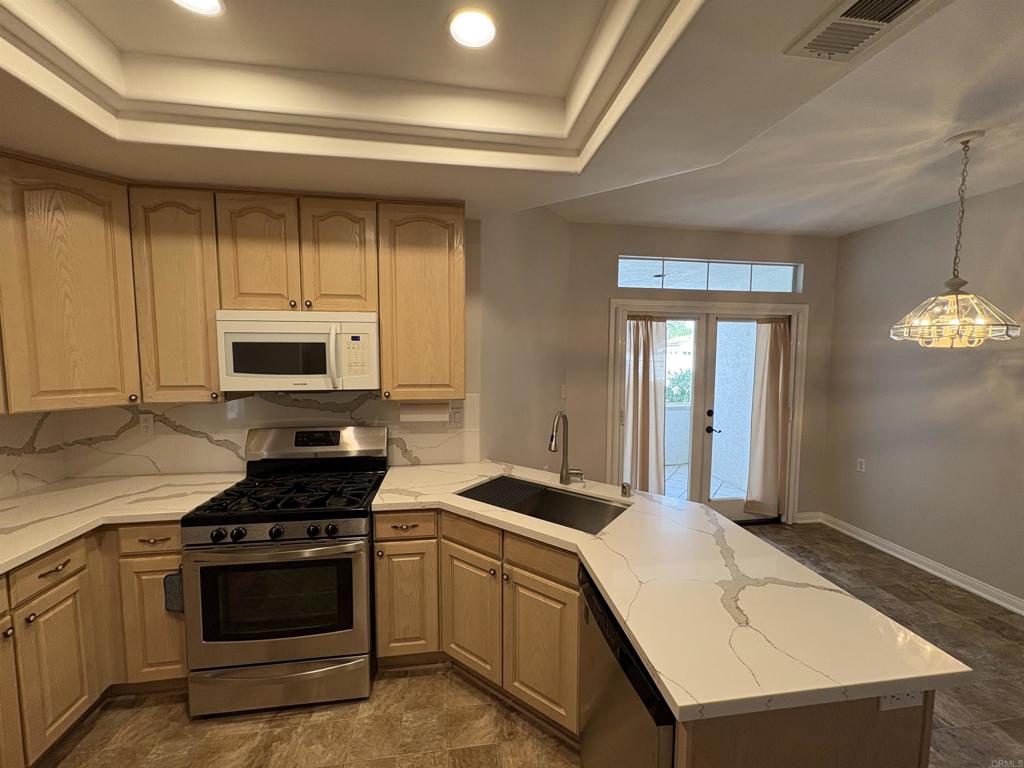 3365 Genoa Way, Unit 138 Oceanside, CA 92056 - Photo 11 of 34 a kitchen with a stove and a white cabinets