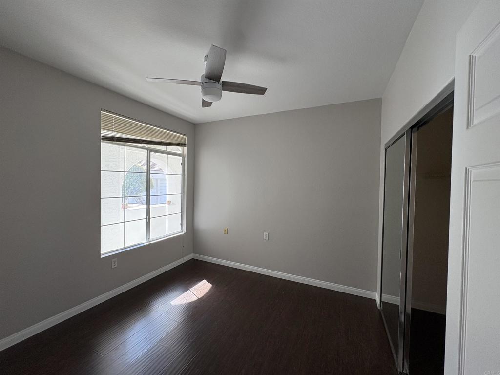 3365 Genoa Way, Unit 138 Oceanside, CA 92056 - Photo 16 of 34 an empty room with a window and wooden floor