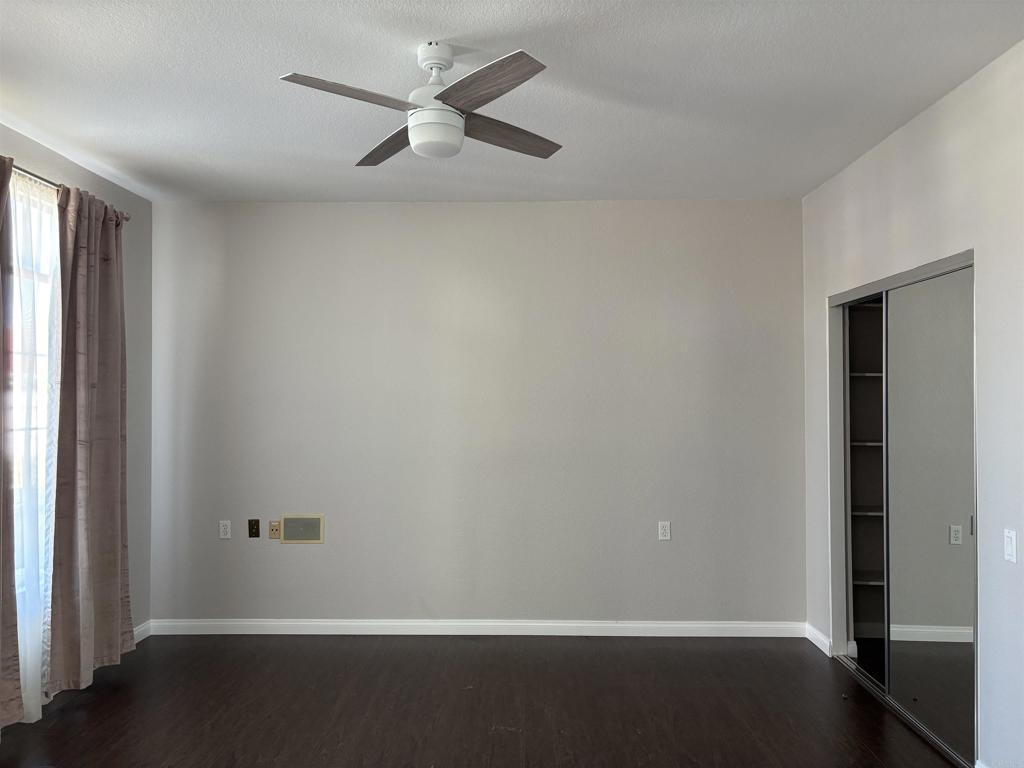 3365 Genoa Way, Unit 138 Oceanside, CA 92056 - Photo 19 of 34 an empty room with a window and a ceiling fan