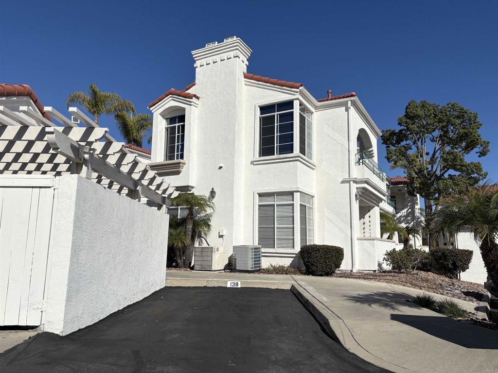 3365 Genoa Way, Unit 138 Oceanside, CA 92056 - Photo 25 of 34 a view of a white apartments with large windows
