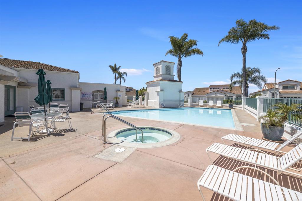 3365 Genoa Way, Unit 138 Oceanside, CA 92056 - Photo 30 of 34 a view of a patio with swimming pool table and chairs