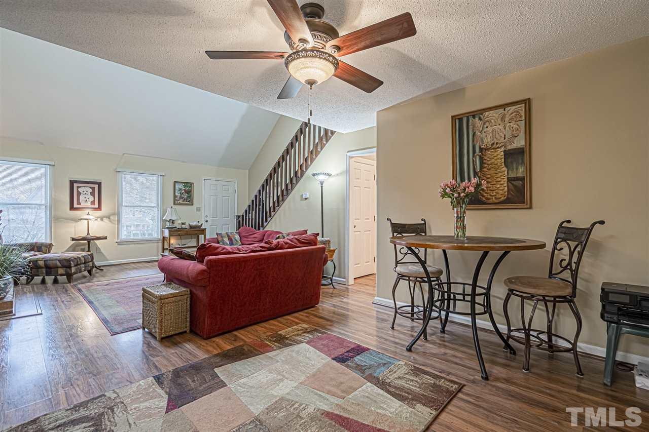 4248 Birmingham Way Raleigh, NC 27604 - Photo 12 of 29 a living room with furniture and a chandelier