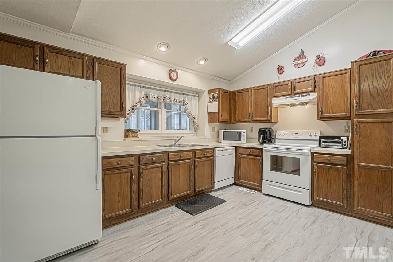 4248 Birmingham Way Raleigh, NC 27604 - Photo 14 of 29 a kitchen with granite countertop a refrigerator stove top oven and sink