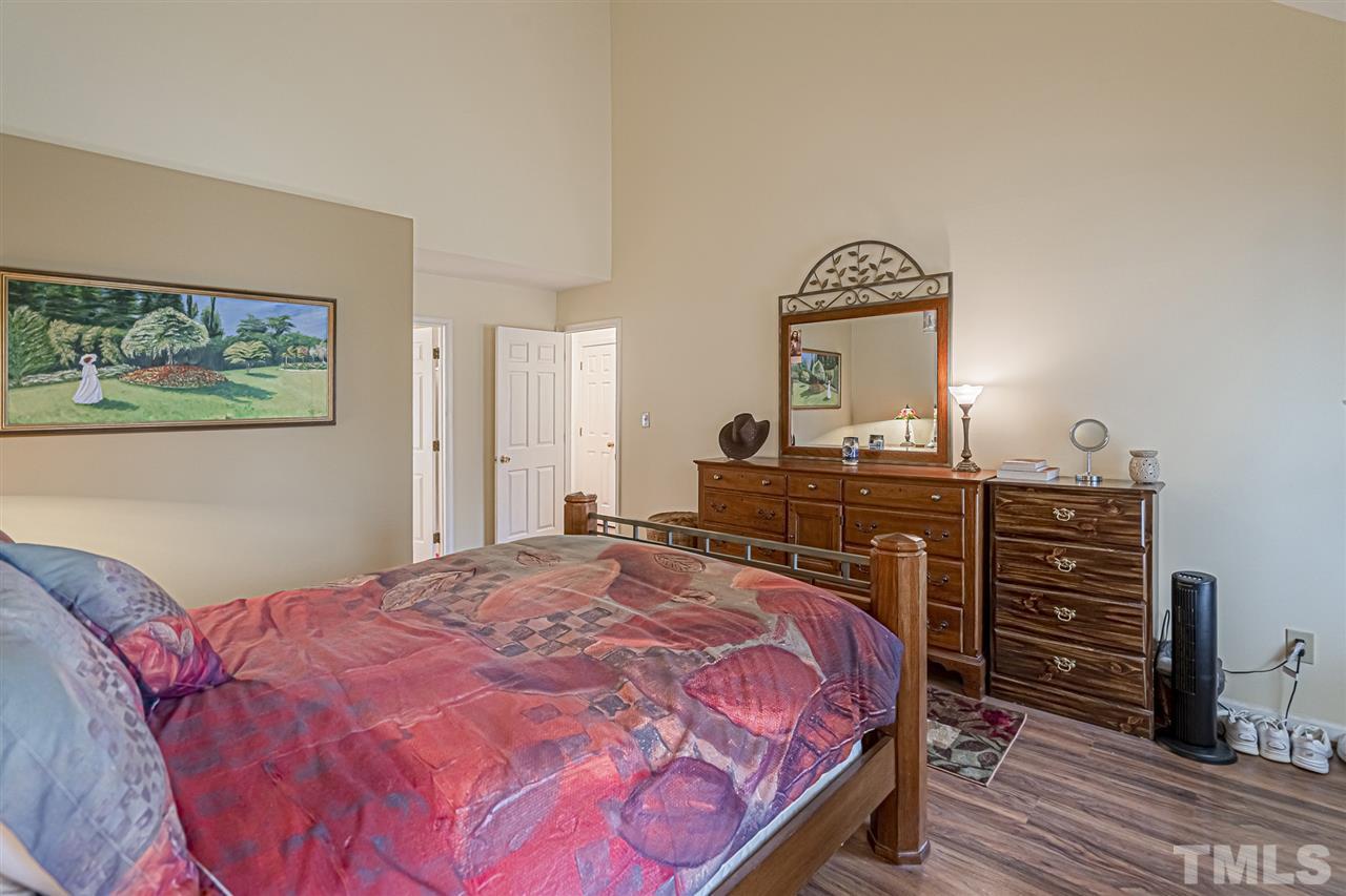 4248 Birmingham Way Raleigh, NC 27604 - Photo 16 of 29 a bedroom with a bed and a dresser