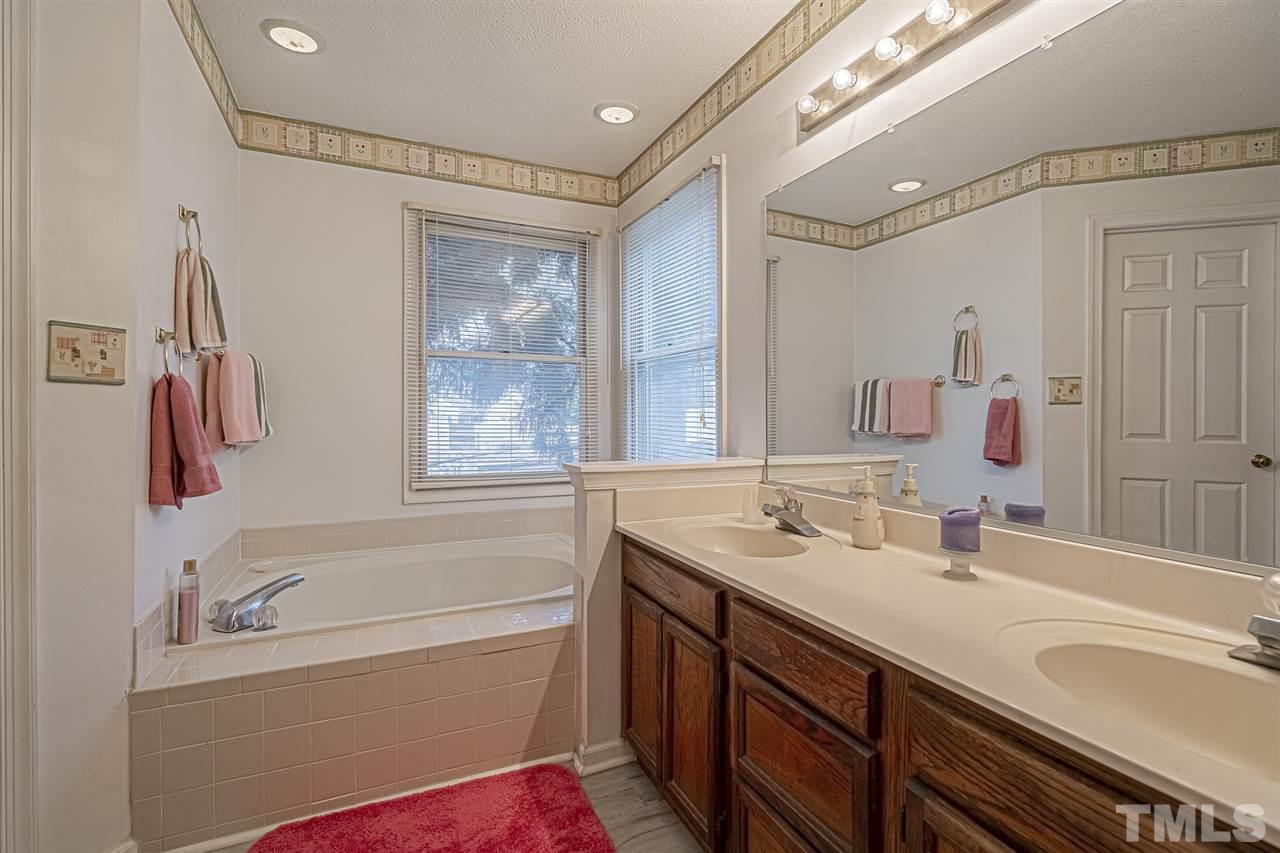 4248 Birmingham Way Raleigh, NC 27604 - Photo 19 of 29 a bathroom with a tub sink and mirror