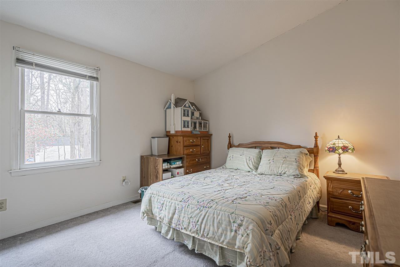 4248 Birmingham Way Raleigh, NC 27604 - Photo 23 of 29 a large bed sitting in a bedroom next to a window