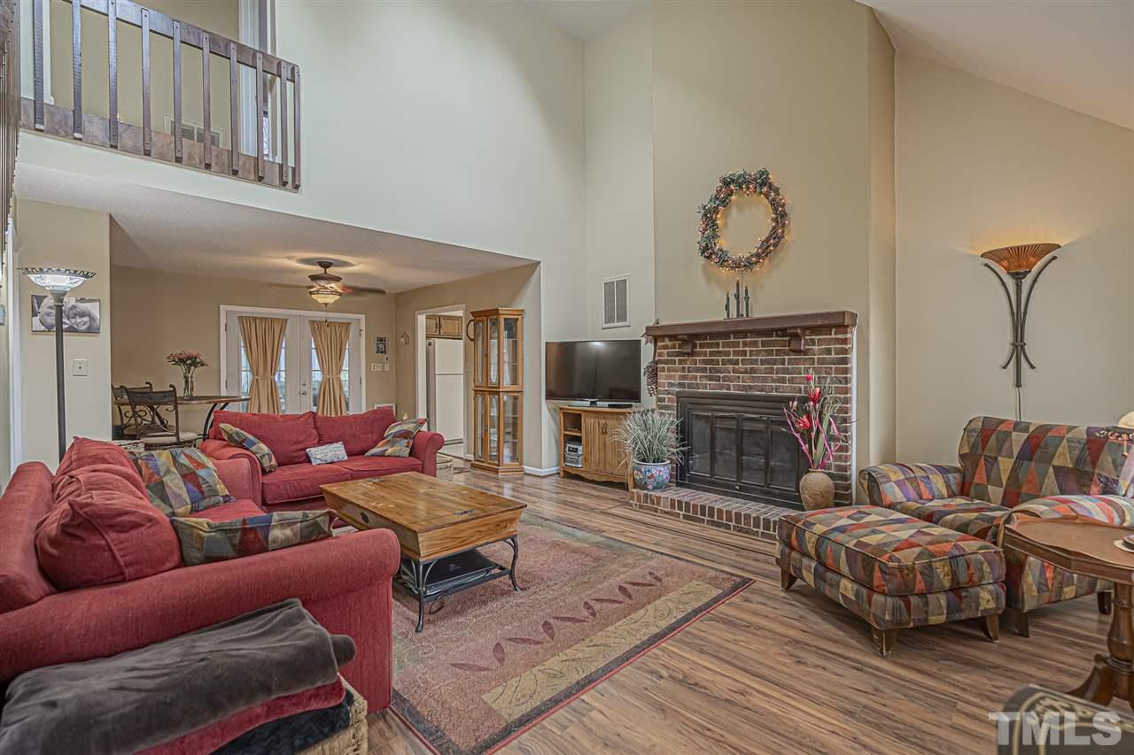 4248 Birmingham Way Raleigh, NC 27604 - Photo 6 of 29 a living room with furniture a fireplace and a flat screen tv