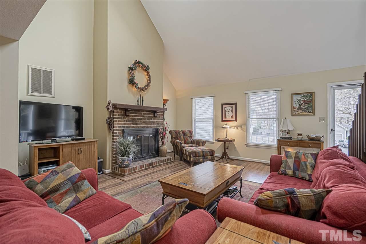 4248 Birmingham Way Raleigh, NC 27604 - Photo 8 of 29 a living room with furniture a flat screen tv and a fireplace