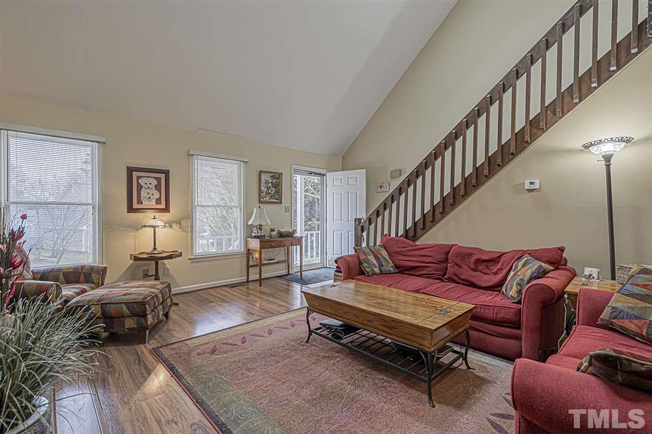 4248 Birmingham Way Raleigh, NC 27604 - Photo 10 of 29 a living room with furniture a couch and a dining table with wooden floor