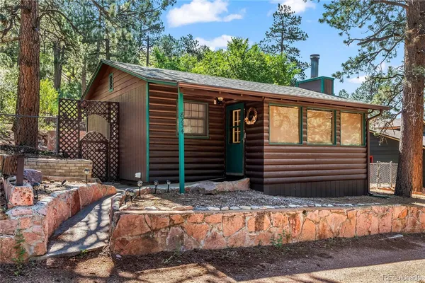 a view of house with backyard and wooden fence
