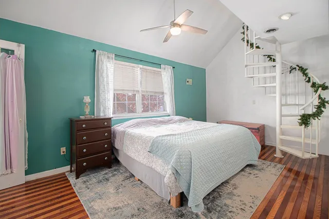 a bedroom with a bed and a dresser