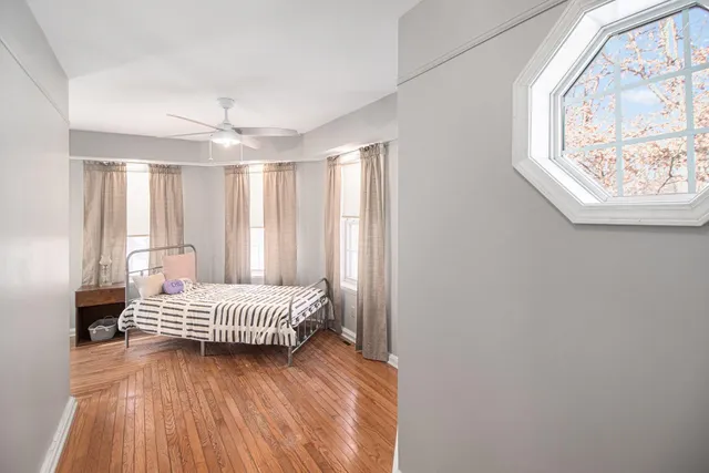 a bedroom with a bed and wooden floor