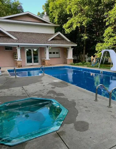 a view of backyard with a chair and potted plants