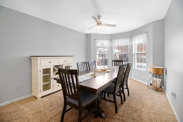 a view of a dining room with furniture and window