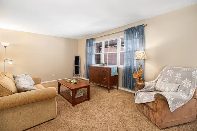 a living room with furniture and windows