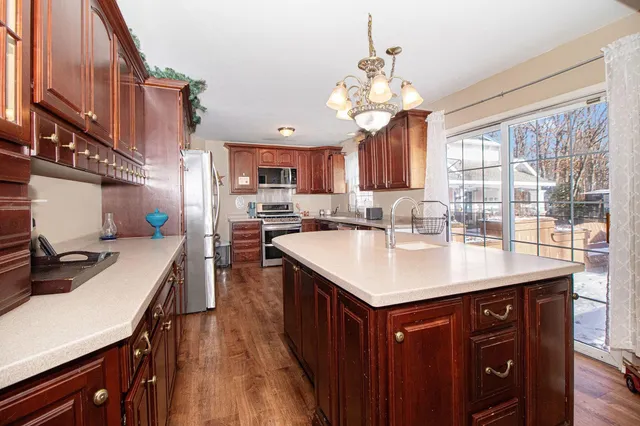 a kitchen with a stove a sink and a refrigerator