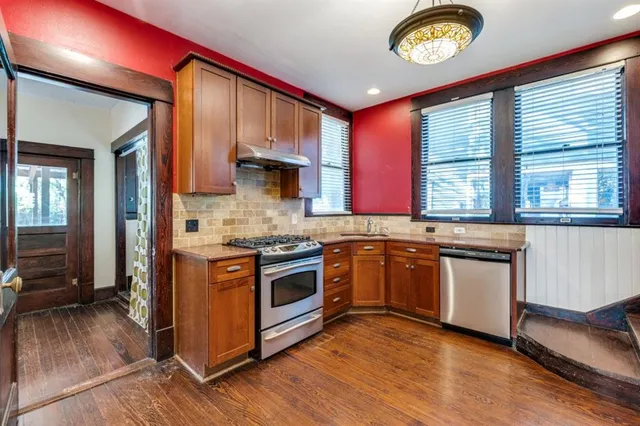a kitchen with a stove top oven a sink and a window