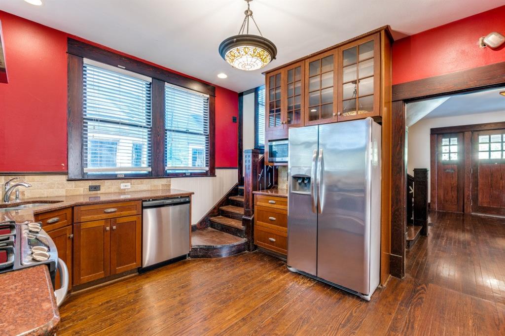 5102 Reiger Avenue Dallas, TX 75214 - Photo 12 of 18 a kitchen with stainless steel appliances granite countertop a refrigerator a stove and a wooden floors