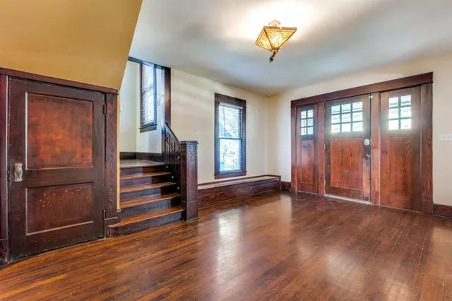 an empty room with wooden floor and a window