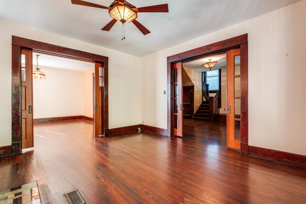 5102 Reiger Avenue Dallas, TX 75214 - Photo 6 of 18 a view of a livingroom with wooden floor and a ceiling fan