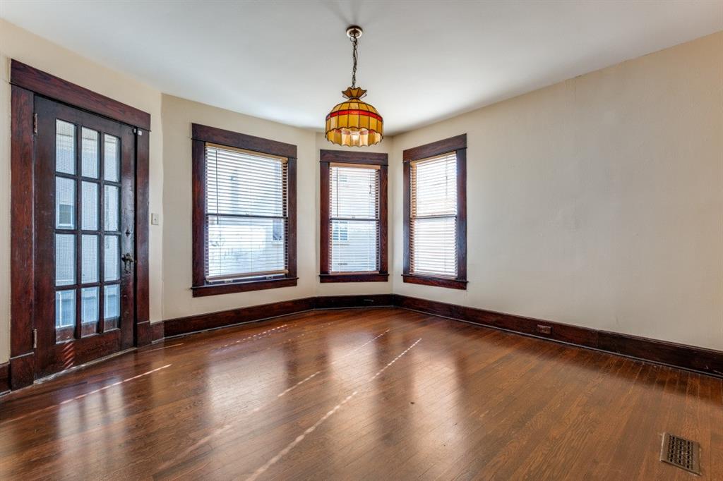 5102 Reiger Avenue Dallas, TX 75214 - Photo 7 of 18 a view of an empty room with window and wooden floor
