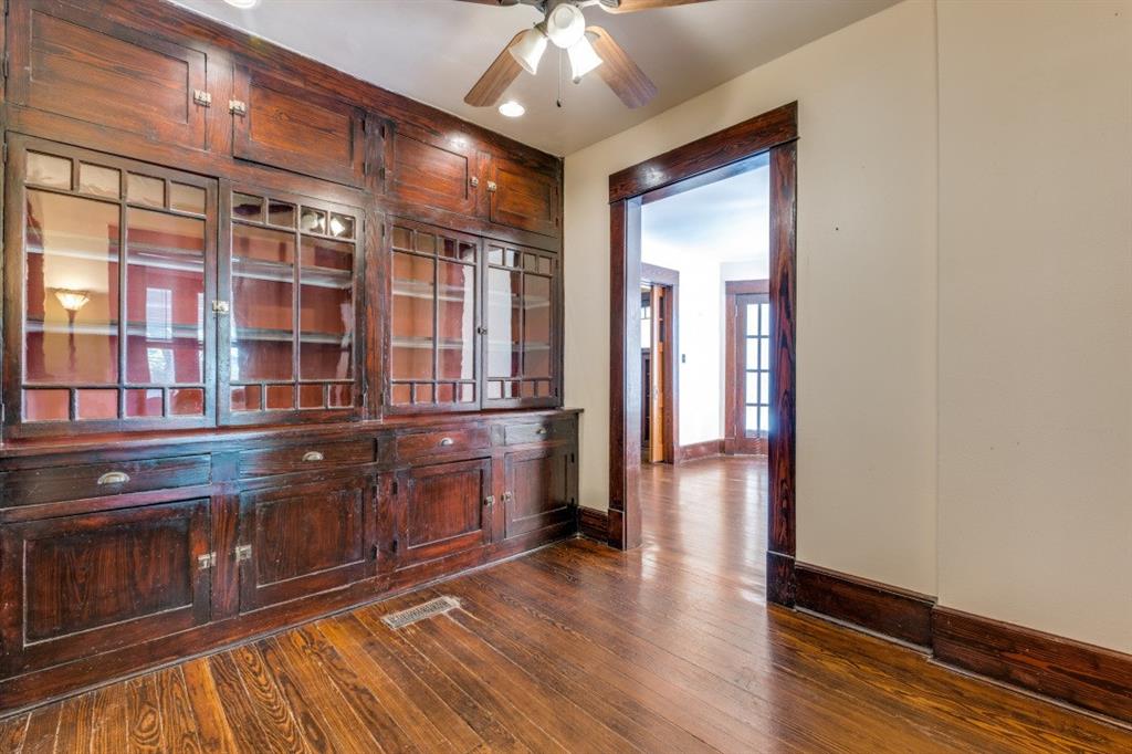 5102 Reiger Avenue Dallas, TX 75214 - Photo 10 of 18 a hallway with wooden floor and chandelier