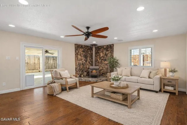a view of empty room with wooden floor and ceiling fan